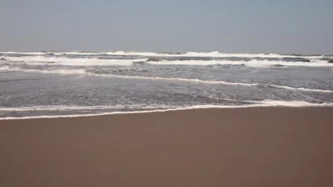 Waves crashing on the brown beach Stock Footage 285753987