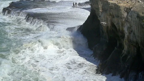 Waves crashing a cliff face Stock Footage 98678831