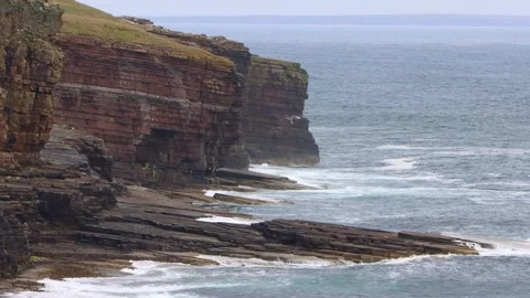 Waves crashing on cliffs (Orkney Islands, Scotland) 4K Stock Footage 317510780