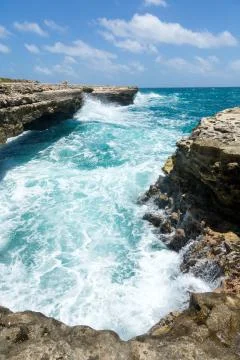 Waves crashing on the coastline devil's bridge antigua Stock Photos