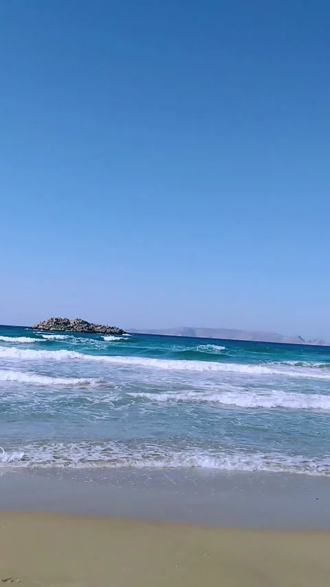 Waves Crashing on Crete Beach with Distant Islands on the Horizon Stock Footage 307754120