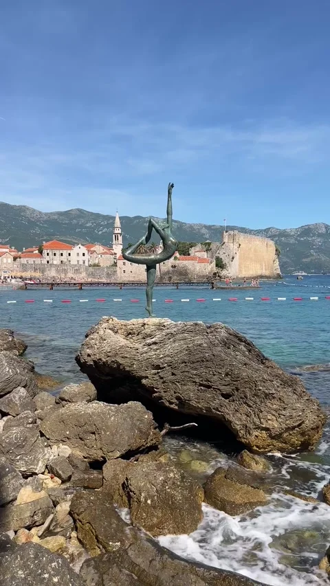Waves Crashing on Dancer Statue with Budva Old Town 4K 스톡 동영상 341698918