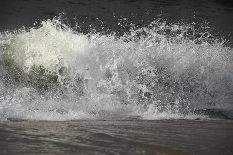 Waves crashing on dark ocean surface during storm Stock Photos