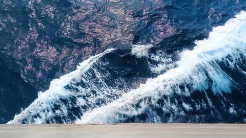 Waves crashing in deep blue sea with white surf foam. Video taken from top .. Stock-Footage 275568244