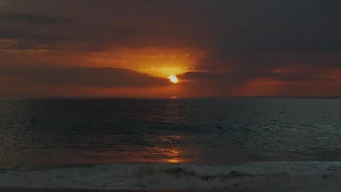 Waves crashing during sunset at a beach in Nazare Stock Footage 304003858