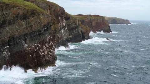 Waves crashing into endless cliffs in the distance Stock Footage 330998792