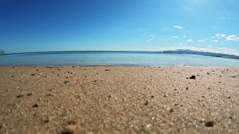 Waves crashing gently on quiet sandy beach on sunset time. Timelapse Stock-Footage 254386910