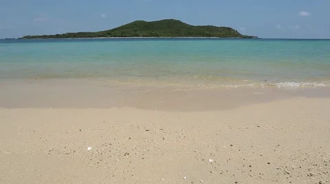 Waves crashing gently on  sandy beach Stock Footage 48787646