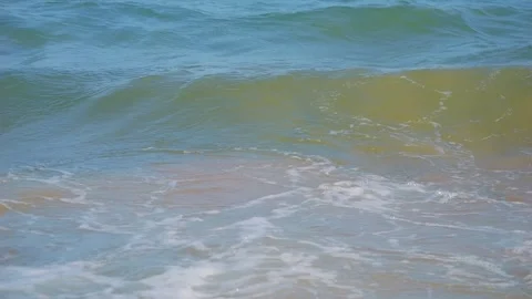 Waves crashing gently on the shore, showcasing the energy of the sea in slo.. Stock Footage 283623517