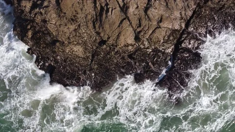 Waves crashing on headland and pull back shot - Porth, Cornwall Stock Footage 220381368