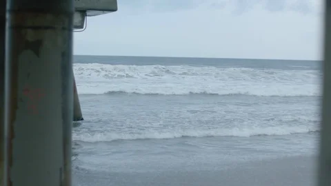 Waves crashing next to a pier 1 Video stock 106629407