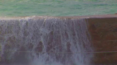 Waves crashing over breakwater Stock Footage 62469265
