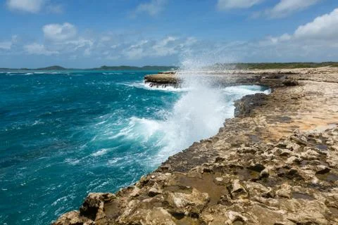 Waves crashing over coastline at devil's bridge antigua Stock Photos