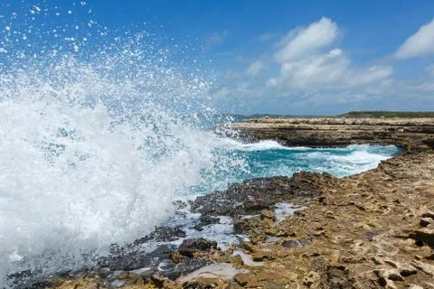 Waves crashing over devil's bridge coastline antigua Stock Photos