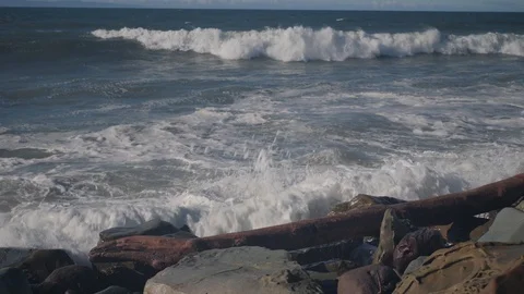 Waves crashing over a log  Stock Footage 100965211