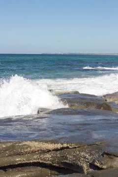 Waves crashing over rocks Stock Photos