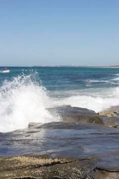 Waves crashing over rocks Stock Photos