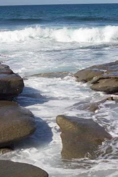 Waves crashing over rocks Stock Photos
