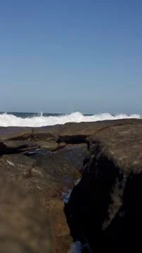 Waves crashing over rocks Stock Photos