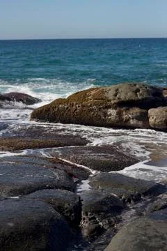 Waves crashing over rocks Stock Photos