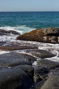 Waves crashing over rocks Stock Photos
