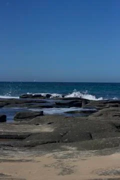 Waves crashing over rocks Stock Photos
