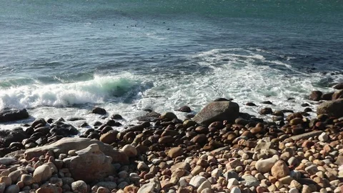 Waves crashing on a pebble beach, near Camp's Bay, Cape Town Stock Footage 102711246