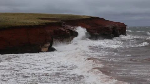 Waves crashing on red sandstone cliffs Stock Footage 164241302