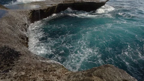 Waves crashing on rock coast Stock Footage 105556623