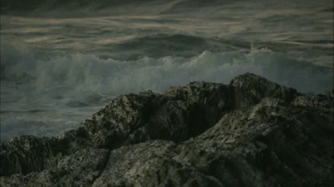 Waves Crashing onto a Rock Stock Footage 37709426