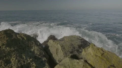Waves crashing on rock Stock Footage 63632337
