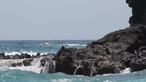 Waves crashing the rock Stock Footage 114238649