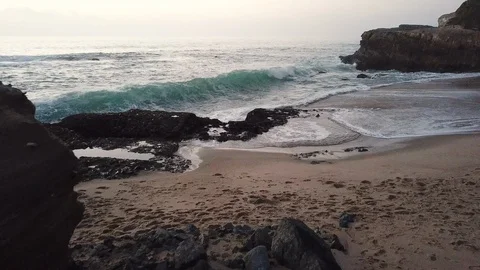 Waves crashing on rock formations on an overcast winter day at Laguna Beach Video stock 104254100