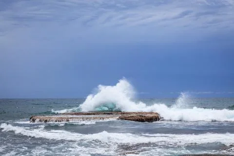 Waves crashing on rock Stock Photos