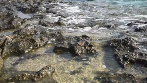 Waves Crashing on Rocks and Sand Stock Footage 321007433