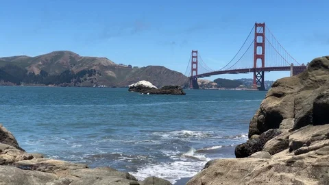 Waves crashing the rocks at Baker beach with Golden Gate bridge Stock Footage 114219768