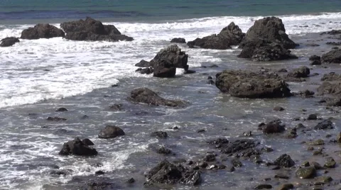 Waves crashing into rocks at the beach Stock Footage 40136585