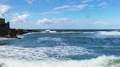 Waves crashing on rocks in Caesarea coastline, dramatic sea landscape, travel an Stock Footage 334458342