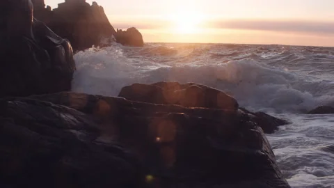 Waves Crashing Into Rocks On Coastline Under Setting Sun Stock Footage 201324936