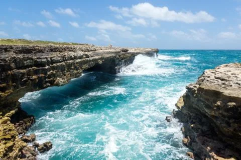 Waves crashing on rocks at devil's bridge antigua Stock Photos