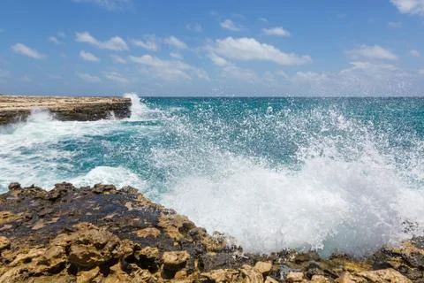 Waves crashing on rocks at devil's bridge antigua Stock Photos