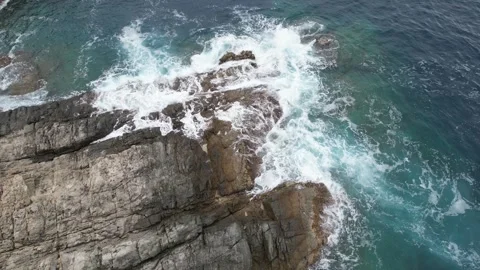 Waves crashing on rocks drone view in Punta Falconera Stock Footage 294198464