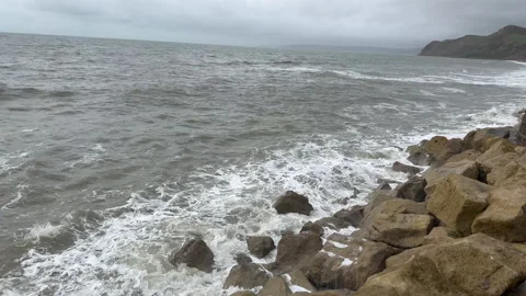 Waves crashing on to rocks Stock Footage 239655701