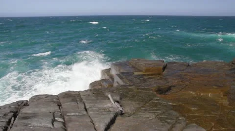 Waves crashing on rocks with a pan left at Green Cape, Australia 動画素材 11260360