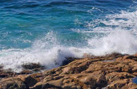 Waves crashing onto rocks Stock Photos