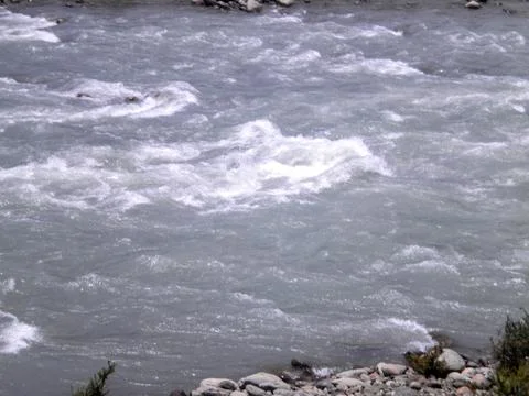 Waves crashing on rocks in the river Stock Photos