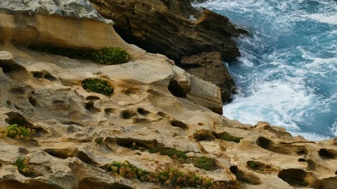 Waves crashing into rocks on the sea coast Stock Footage