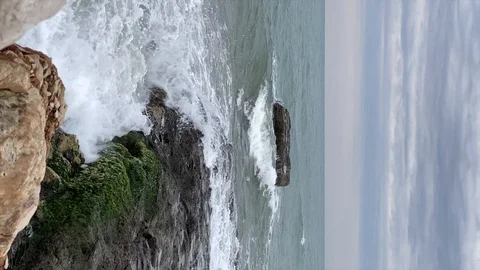 Waves crashing on rocks on the seaside. Slow motion. Vertical video Stock Footage 124944546