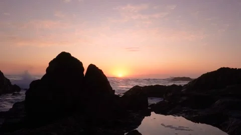 Waves crashing on rocks at sunset Stock Footage 315761489