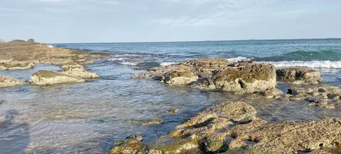 Waves Crashing on a rocky beach Stock Footage 163941129